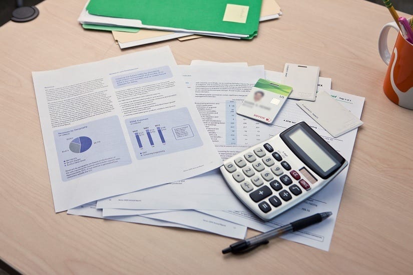 Cost savings calculator and papers on a table